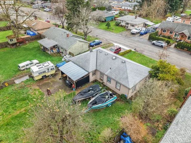 an aerial view of a house with a garden and swimming pool