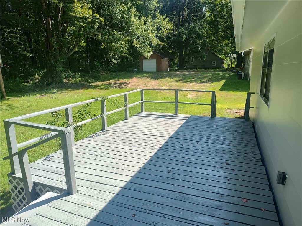 8016 Ninevah Road Geneva, OH 44041 - Photo 12 of 45 Wooden deck featuring a lawn and an outbuilding