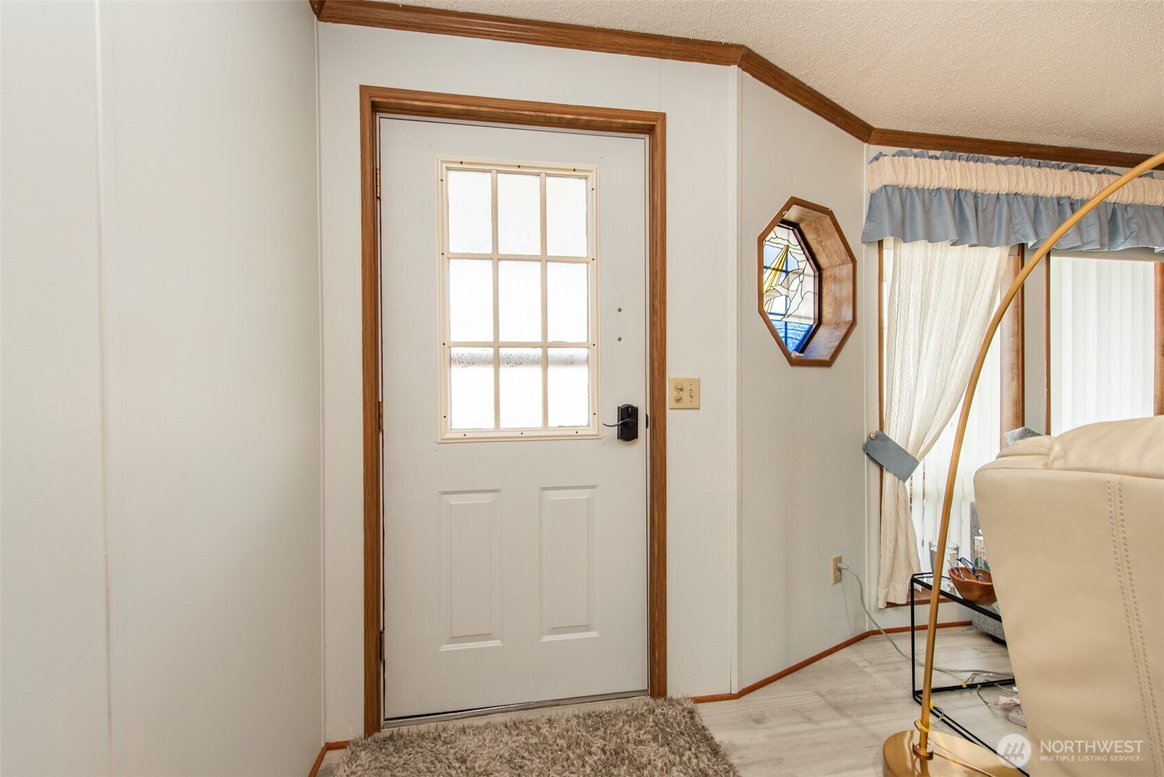 325 North 5th Avenue, Unit 48 Sequim, WA 98382 - Photo 9 of 40 a view of a hallway with wooden floor and windows