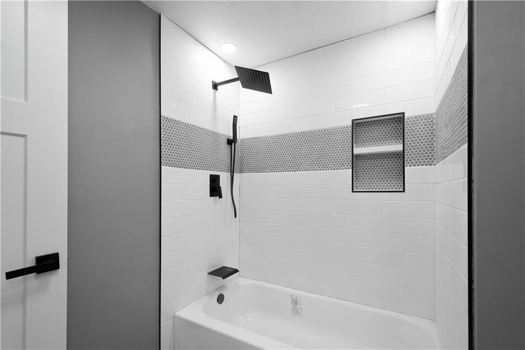 933 Boyce Road Bridgeville, PA 15017 - Photo 17 of 36 a bathroom with a bathtub and a shower