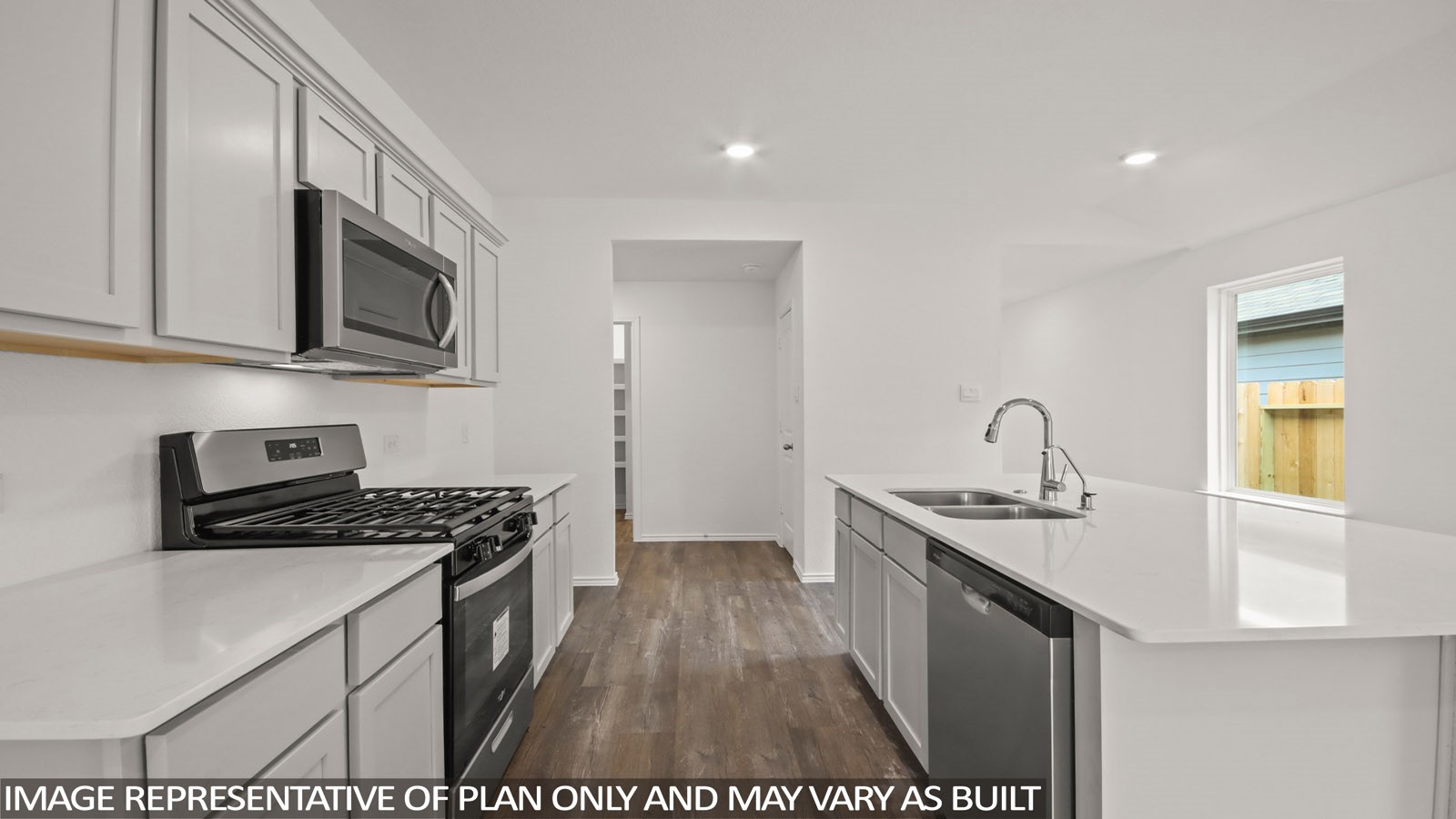 1690 Portia Lane Conroe, TX 77301 - Photo 2 of 18 a kitchen with stainless steel appliances a sink a stove a microwave a sink and cabinets
