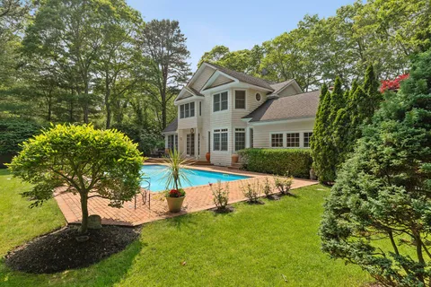 a front view of a house with a yard table and chairs