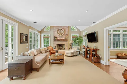 a living room with fireplace furniture and a flat screen tv