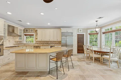 a kitchen with stainless steel appliances kitchen island granite countertop a sink and cabinets