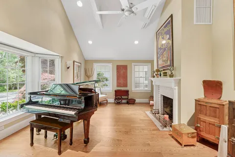 a living room with furniture a fireplace and a table