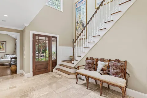 a living room with furniture and stairs