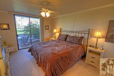 28 Calle Encinitas Rancho Mirage, CA 92270 - Photo 12 of 25 a bedroom with a bed and a lamp next to a window