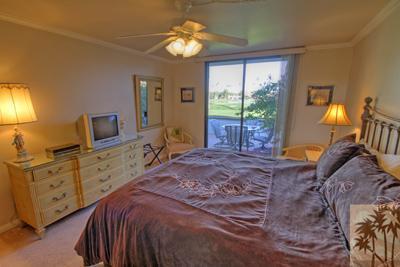28 Calle Encinitas Rancho Mirage, CA 92270 - Photo 13 of 25 a bed room with a bed and a chandelier