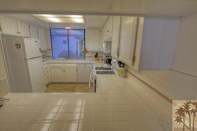28 Calle Encinitas Rancho Mirage, CA 92270 - Photo 9 of 25 a view of a hallway with dining area and chandelier