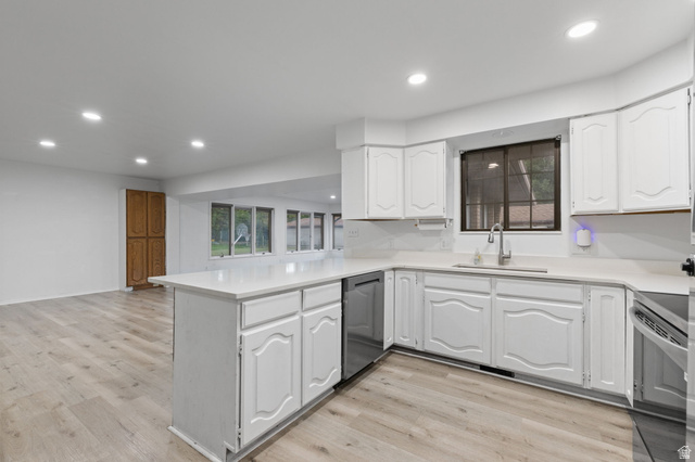 875 Cedar Hollow Road Lehi, UT 84043 - Photo 65 of 76 White cabinetry with integrated appliances, light-toned countertops, and wood-finish flooring