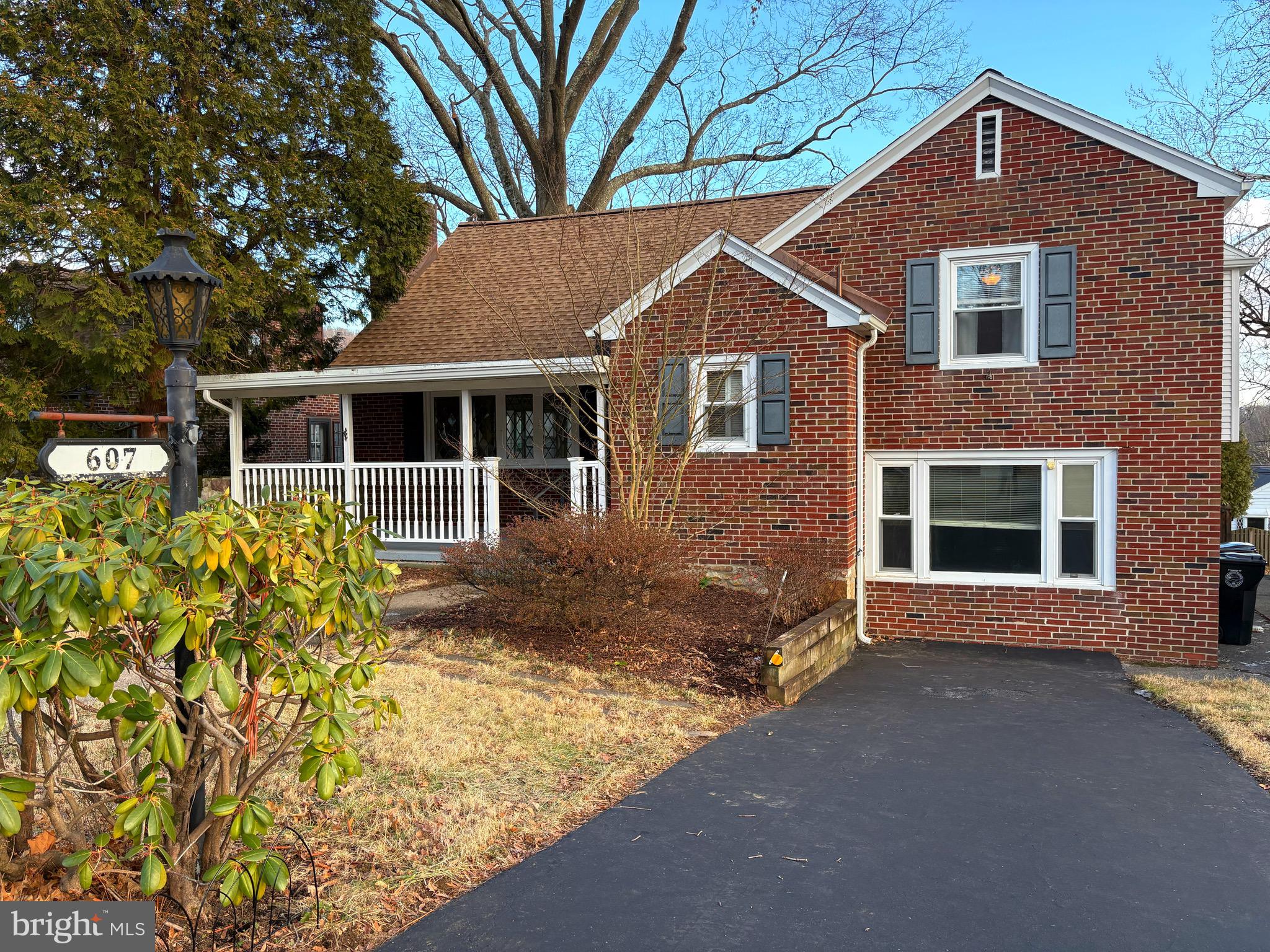 a front view of a house with a yard and potted plants