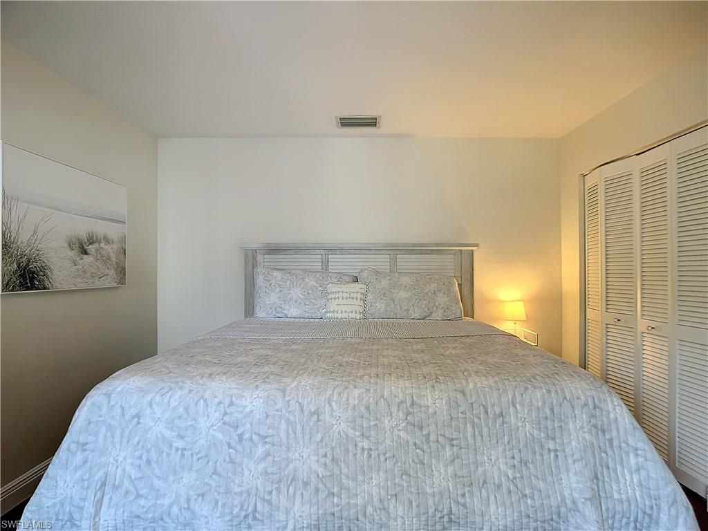 2860 Citrus Lake Drive, Unit R202 Naples, FL 34109 - Photo 32 of 50 a bedroom with a bed and wall painting