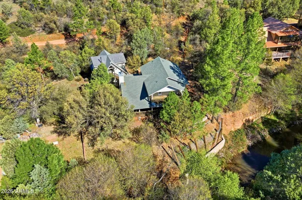 an aerial view of residential house with green space