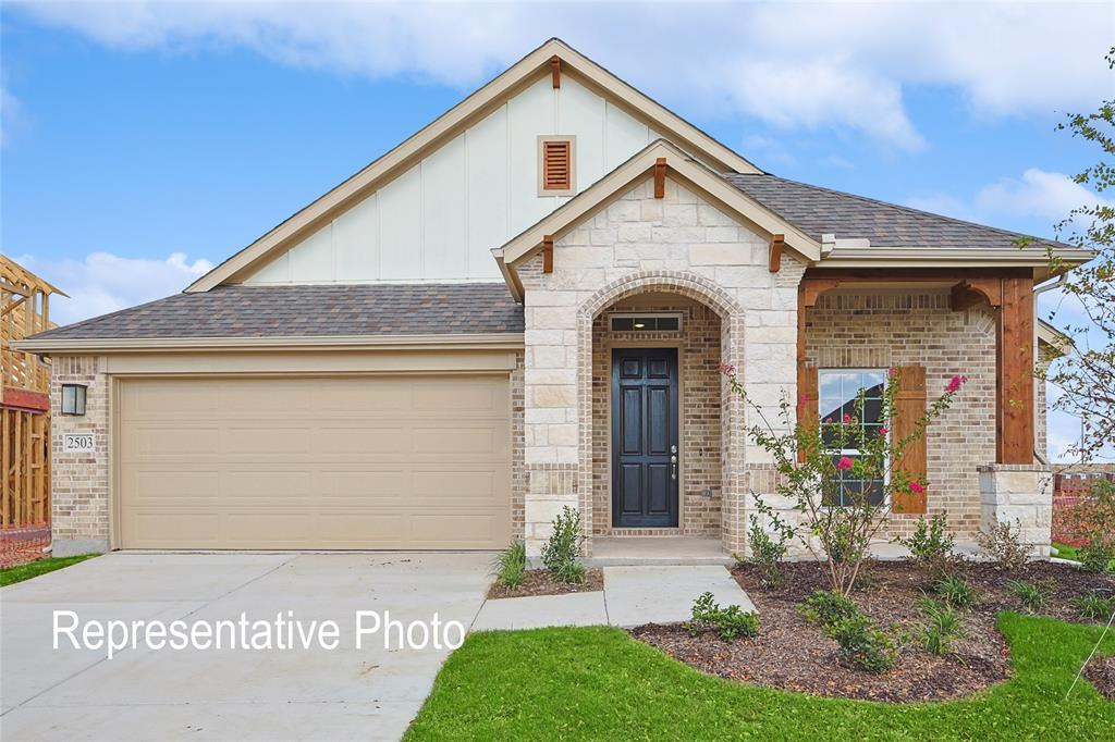 1127 Rothland Court Red Oak, TX 75154 - Photo 1 of 1 View of front of home with board and batten siding, brick siding, concrete driveway, and a garage