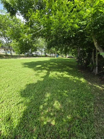 a view of a green field with sitting area