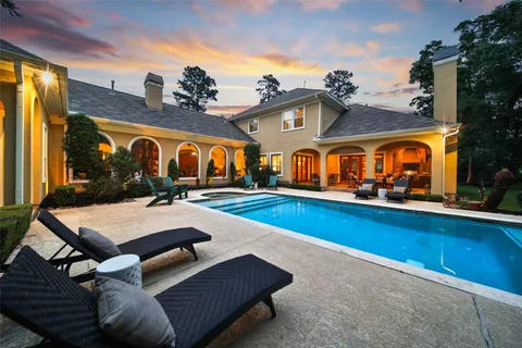 an aerial view of residential house with outdoor space and trees all around
