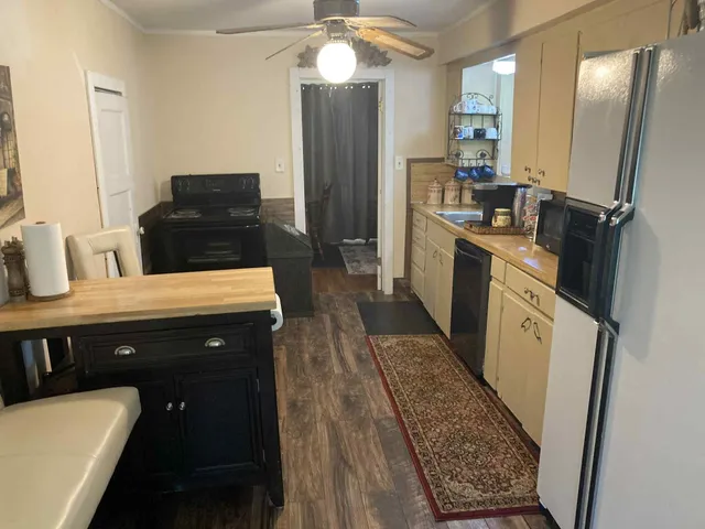 a kitchen with a sink stove and refrigerator