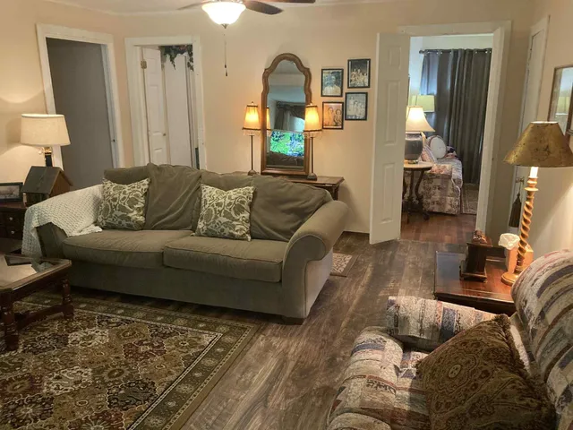 a living room with furniture and a wooden floor