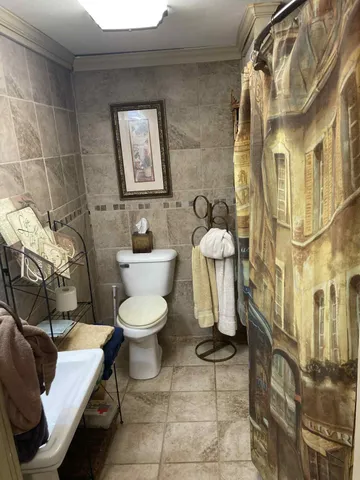 a white toilet sitting next to a bathroom sink