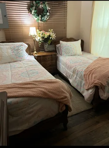 a bedroom with a bed and a potted plant