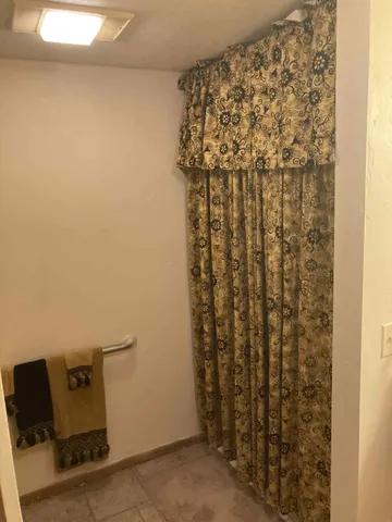 a bathroom with a shower curtain