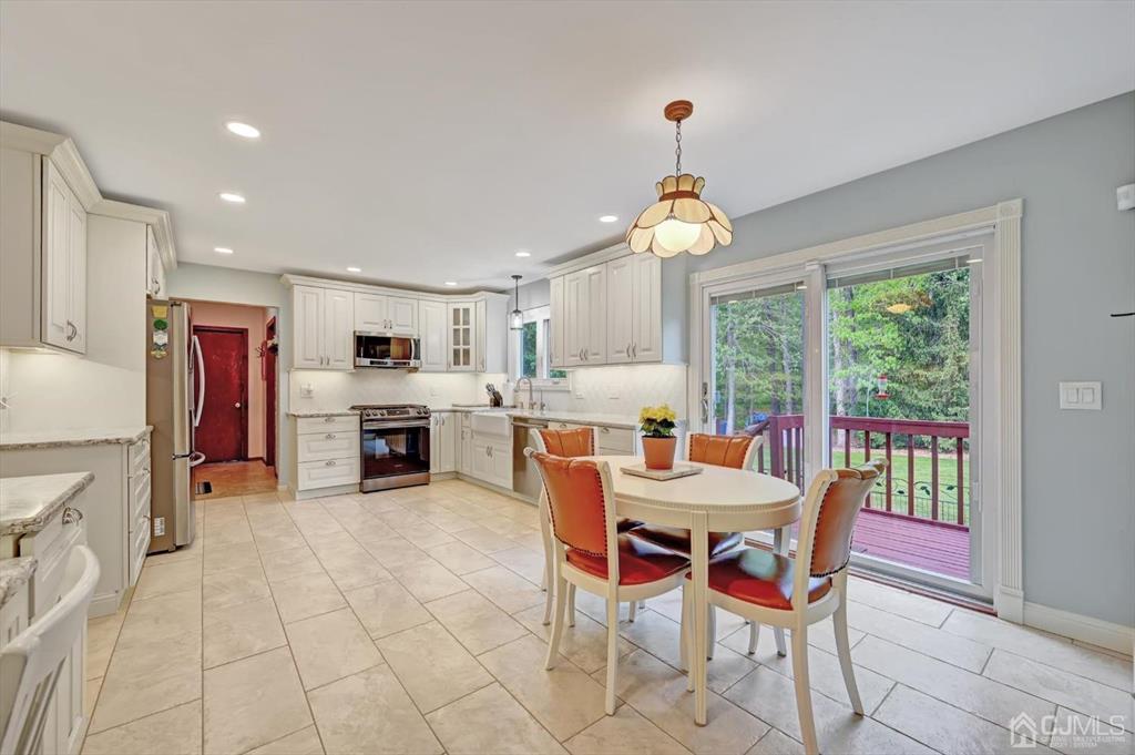 38 Pittenger Pond Road Freehold, NJ 07728 - Photo 11 of 43 a dining room with furniture a chandelier and kitchen view