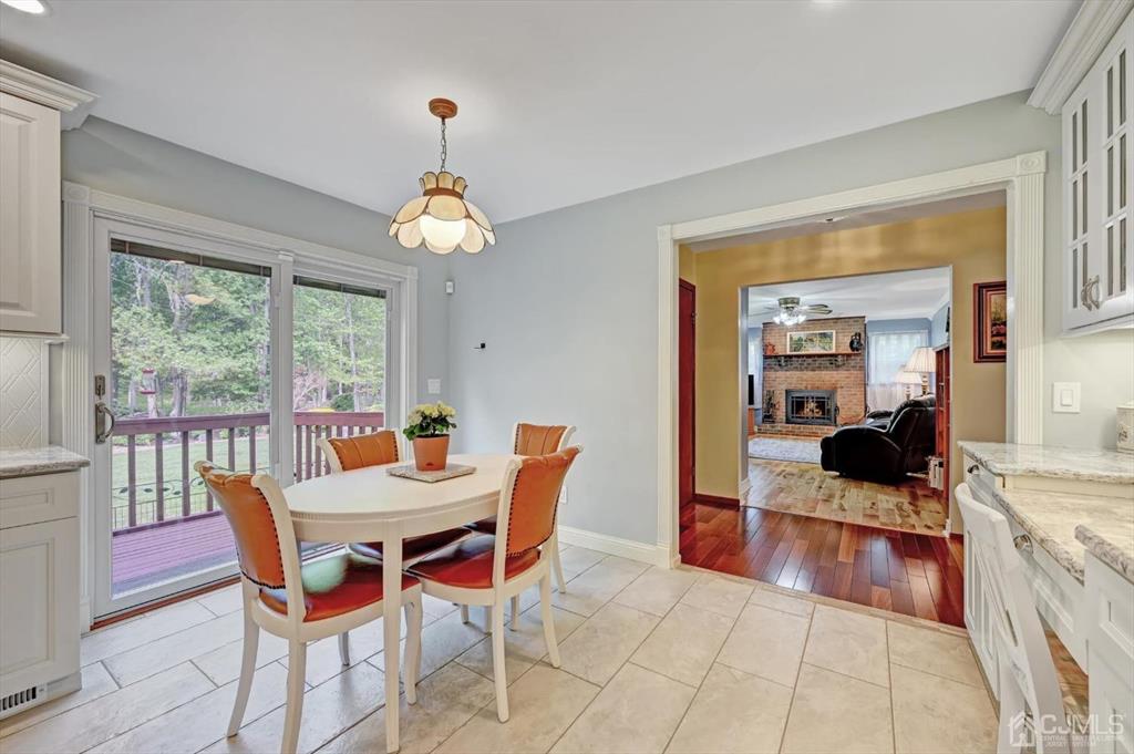 38 Pittenger Pond Road Freehold, NJ 07728 - Photo 15 of 43 a dining room with furniture a chandelier and wooden floor