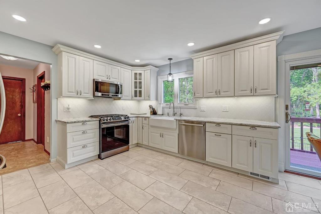 38 Pittenger Pond Road Freehold, NJ 07728 - Photo 16 of 43 a kitchen with cabinets stainless steel appliances and a window