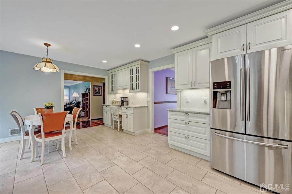 38 Pittenger Pond Road Freehold, NJ 07728 - Photo 17 of 43 a kitchen with white cabinets and stainless steel appliances