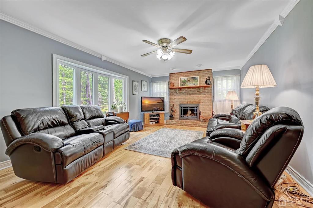 38 Pittenger Pond Road Freehold, NJ 07728 - Photo 18 of 43 a living room with furniture a fireplace and a flat screen tv