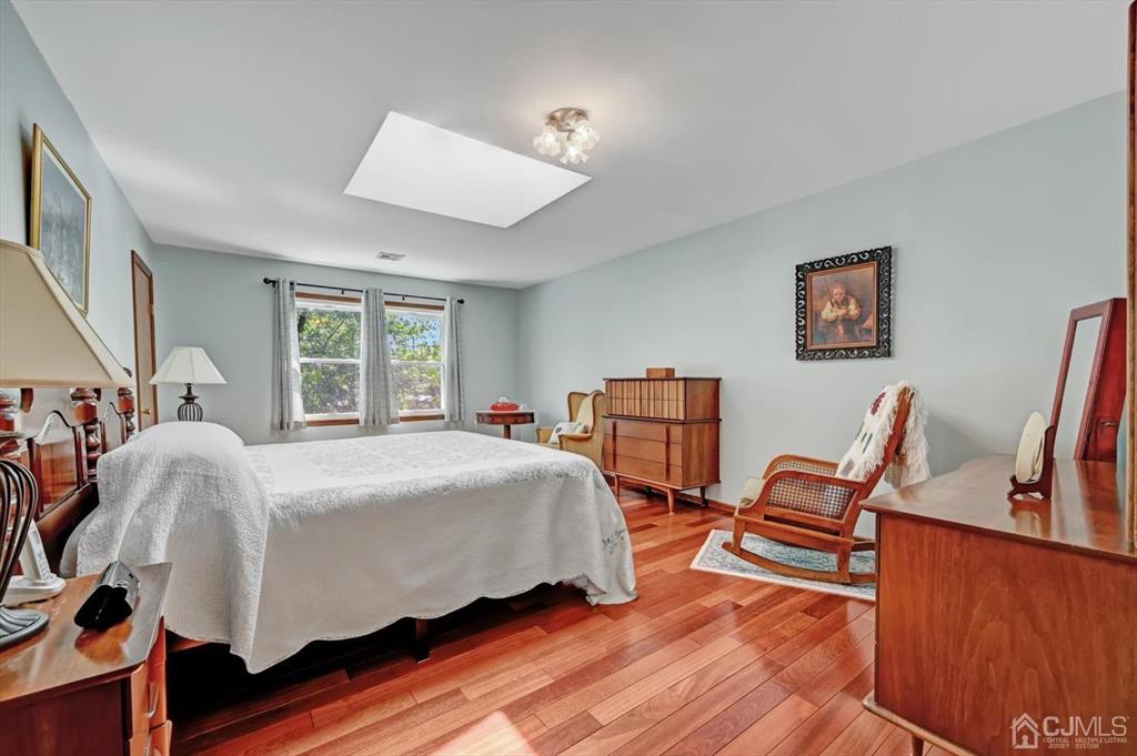 38 Pittenger Pond Road Freehold, NJ 07728 - Photo 24 of 43 a bed room with a bed and two chairs
