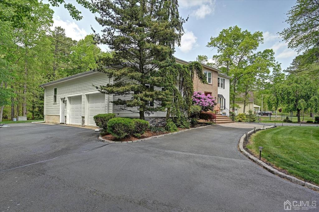 38 Pittenger Pond Road Freehold, NJ 07728 - Photo 38 of 43 a view of a house with a yard and potted plants