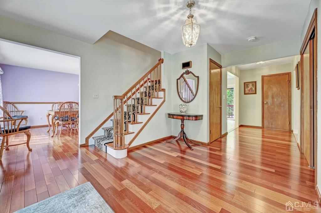 38 Pittenger Pond Road Freehold, NJ 07728 - Photo 4 of 43 a view of a hallway with wooden floor and staircase