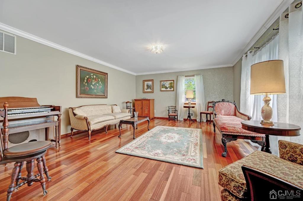 38 Pittenger Pond Road Freehold, NJ 07728 - Photo 5 of 43 a living room with furniture a piano and wooden floor
