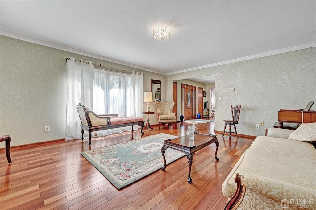 38 Pittenger Pond Road Freehold, NJ 07728 - Photo 6 of 43 a living room with furniture and a wooden floor