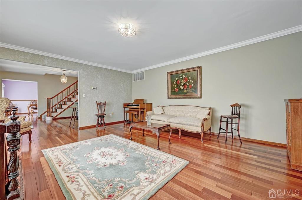 38 Pittenger Pond Road Freehold, NJ 07728 - Photo 7 of 43 a living room with furniture and wooden floor