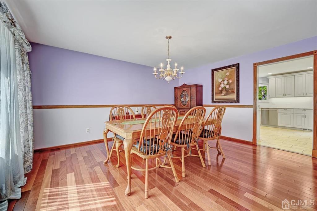 38 Pittenger Pond Road Freehold, NJ 07728 - Photo 8 of 43 a view of a dining room with furniture wooden floor and chandelier
