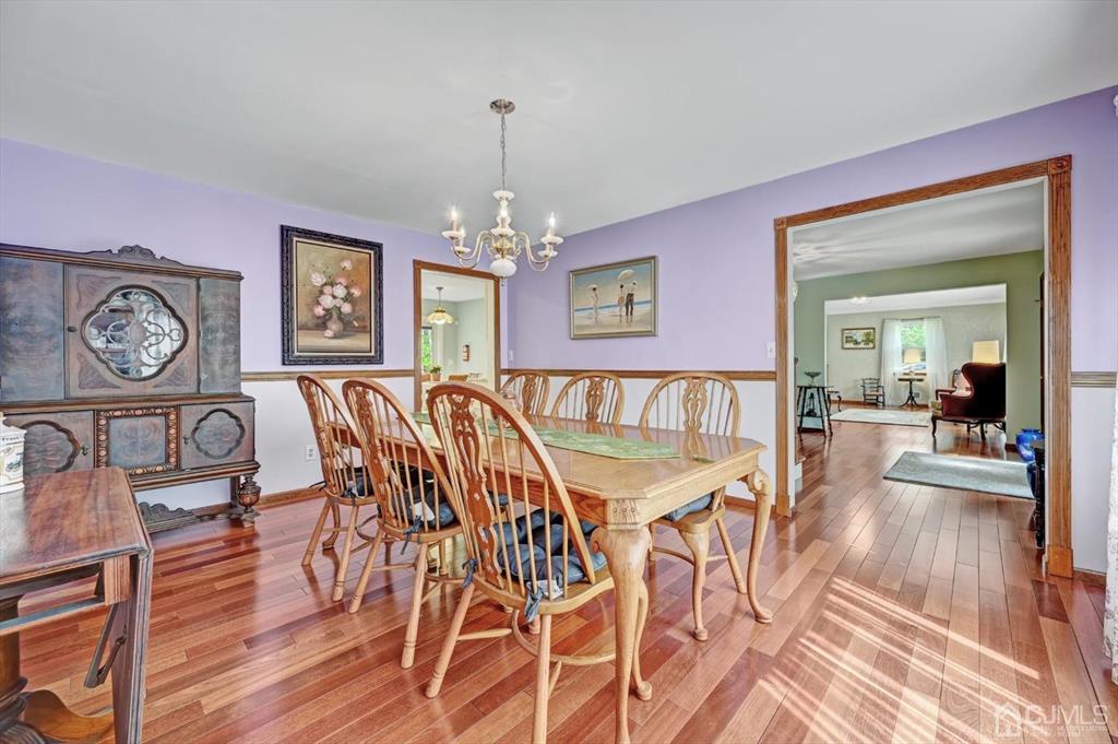 38 Pittenger Pond Road Freehold, NJ 07728 - Photo 9 of 43 a dining room with furniture a chandelier and wooden floor