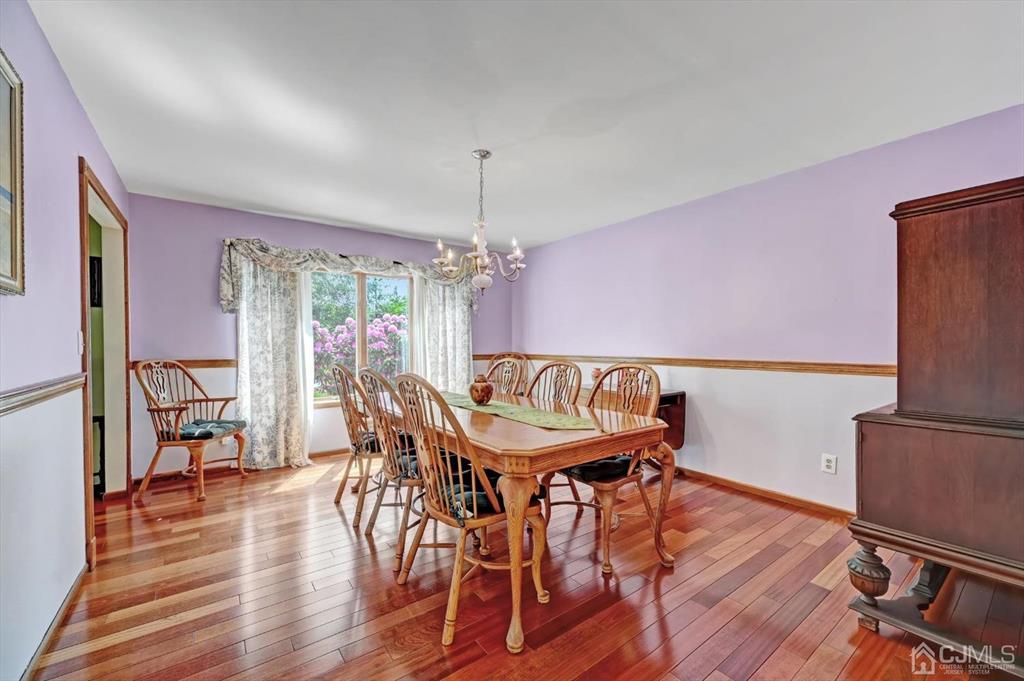 38 Pittenger Pond Road Freehold, NJ 07728 - Photo 10 of 43 a dining room with furniture a chandelier and wooden floor