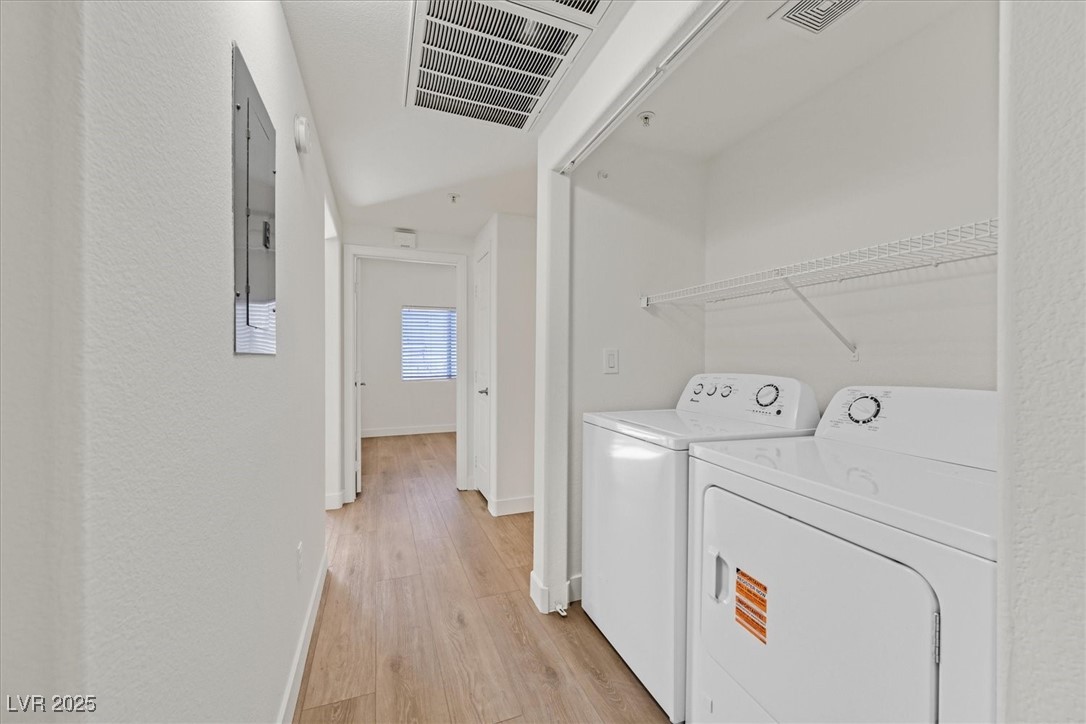 2291 West Horizon Ridge Parkway, Unit 1206 Henderson, NV 89052 - Photo 15 of 29 Laundry area with light wood-type flooring and washing machine and dryer