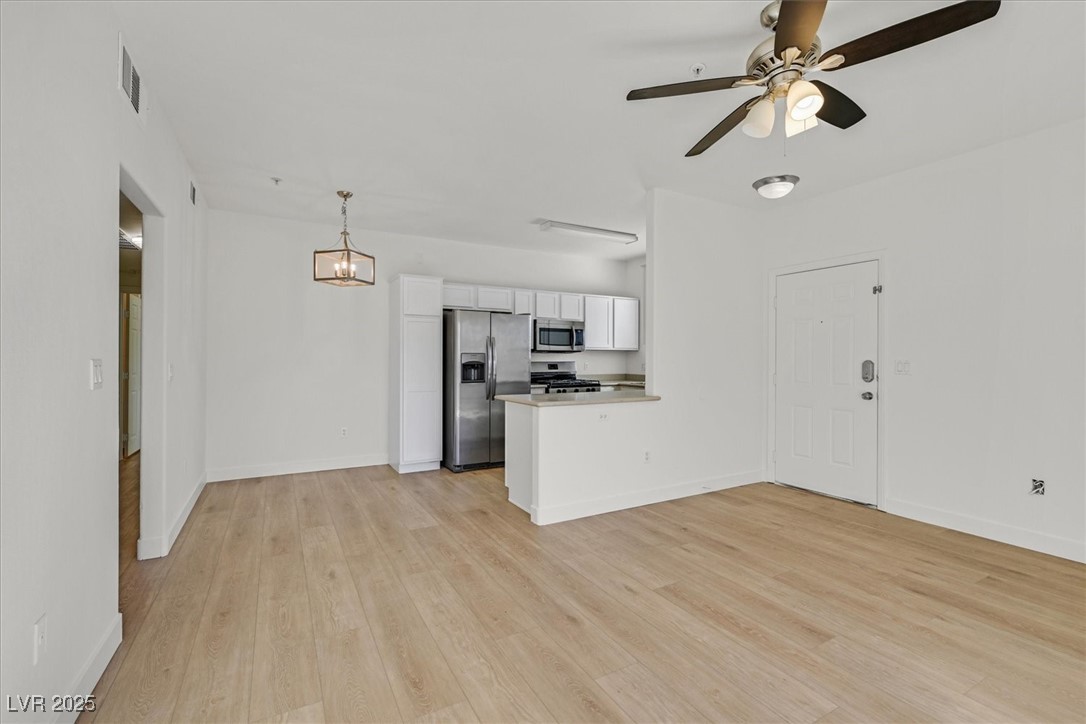 2291 West Horizon Ridge Parkway, Unit 1206 Henderson, NV 89052 - Photo 29 of 29 Kitchen with a peninsula, white cabinetry, appliances with stainless steel finishes, light countertops, and open floor plan