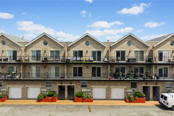 a front view of a house with a yard and balcony