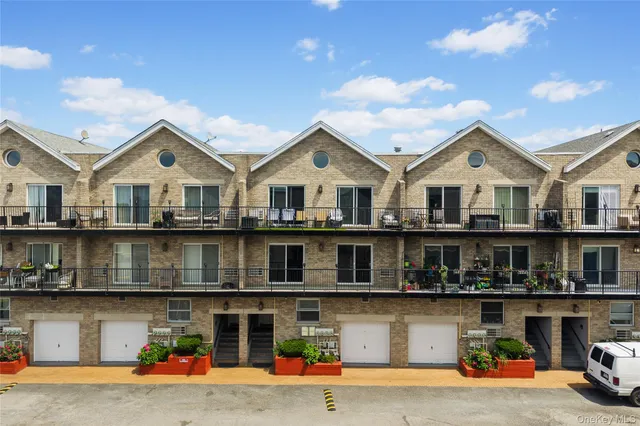 a front view of a house with a yard and balcony