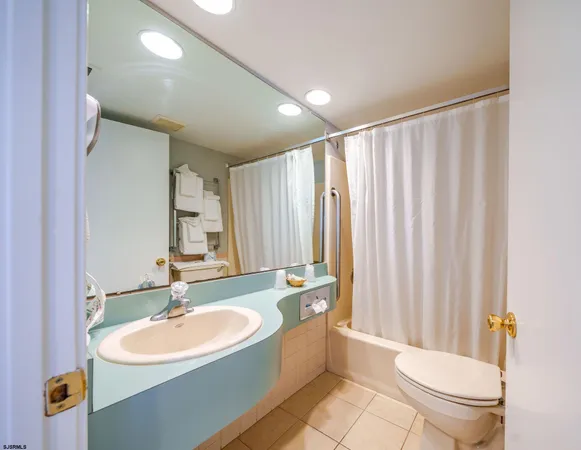 a bedroom with a bed and a large mirror