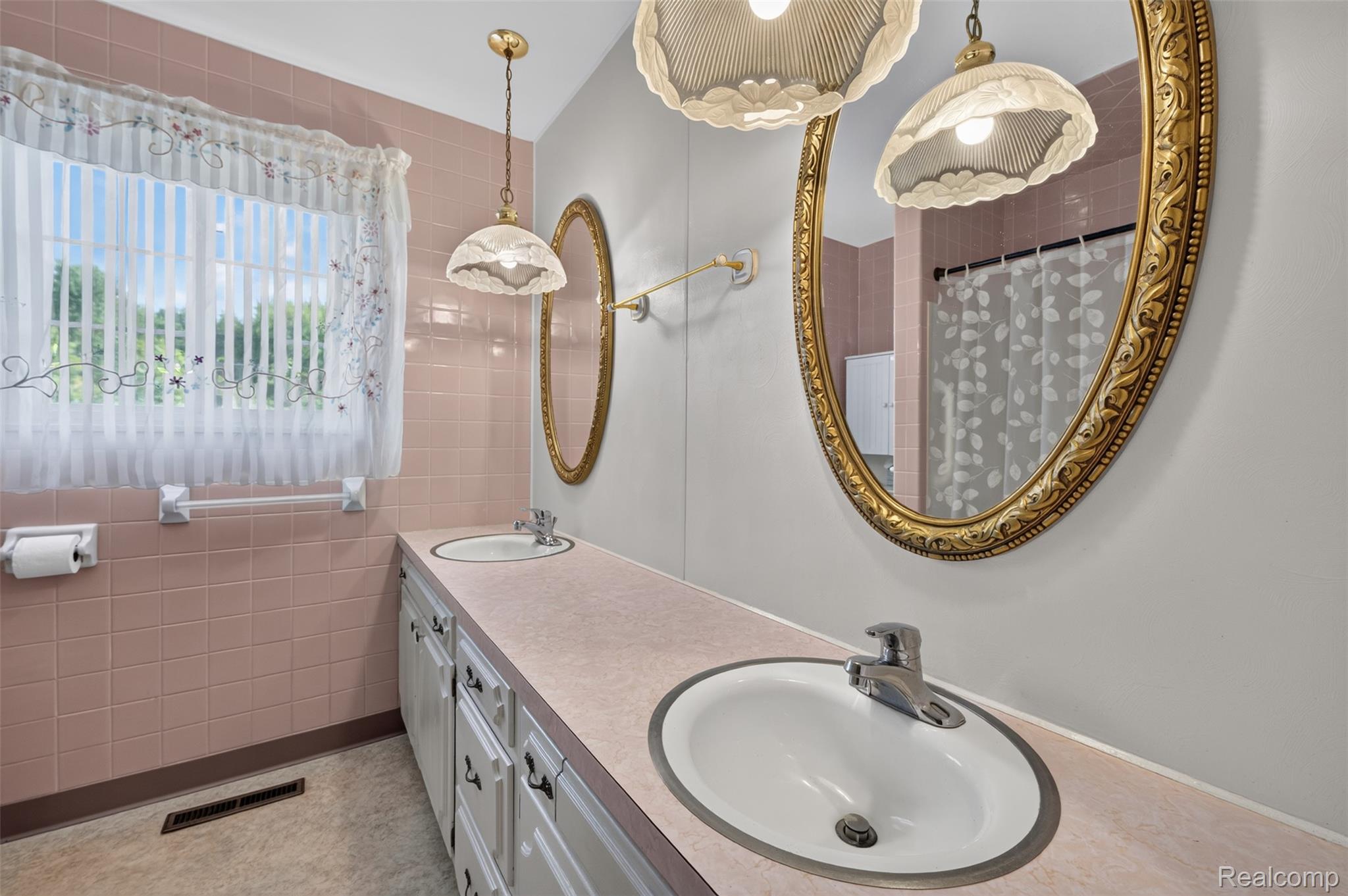 12055 West Pierson Road Flushing, MI 48433 - Photo 36 of 69 Dual vanity with integrated sinks, ornate framed mirrors, and pendant lighting