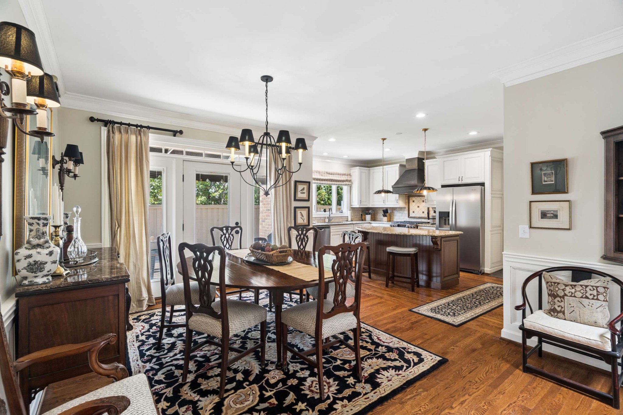 2723 Abbott Martin Road Nashville, TN 37215 - Photo 15 of 45 a view of a dining room and livingroom with furniture wooden floor a rug a painting and a chandelier