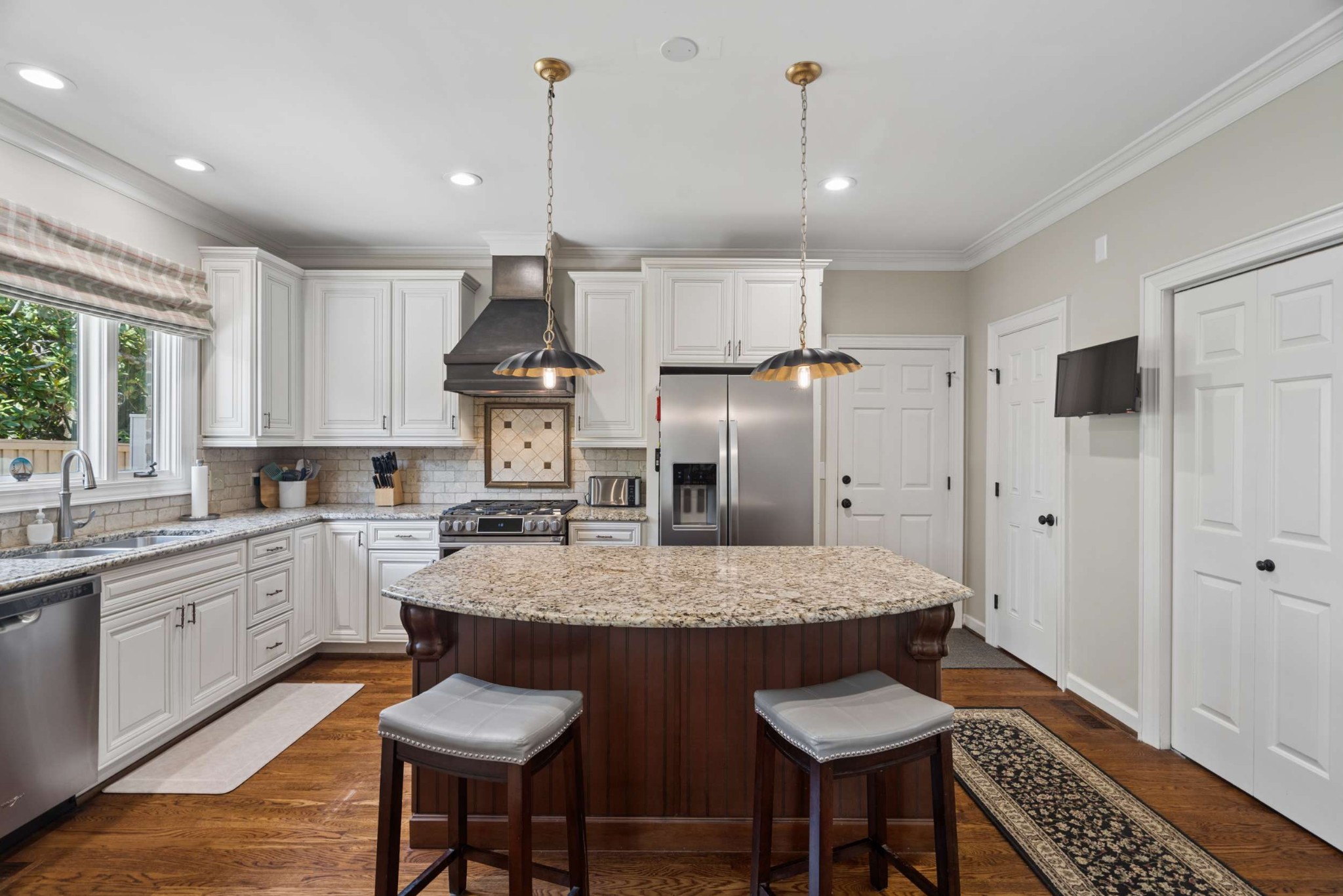 2723 Abbott Martin Road Nashville, TN 37215 - Photo 18 of 45 a kitchen with granite countertop a table chairs stainless steel appliances and window