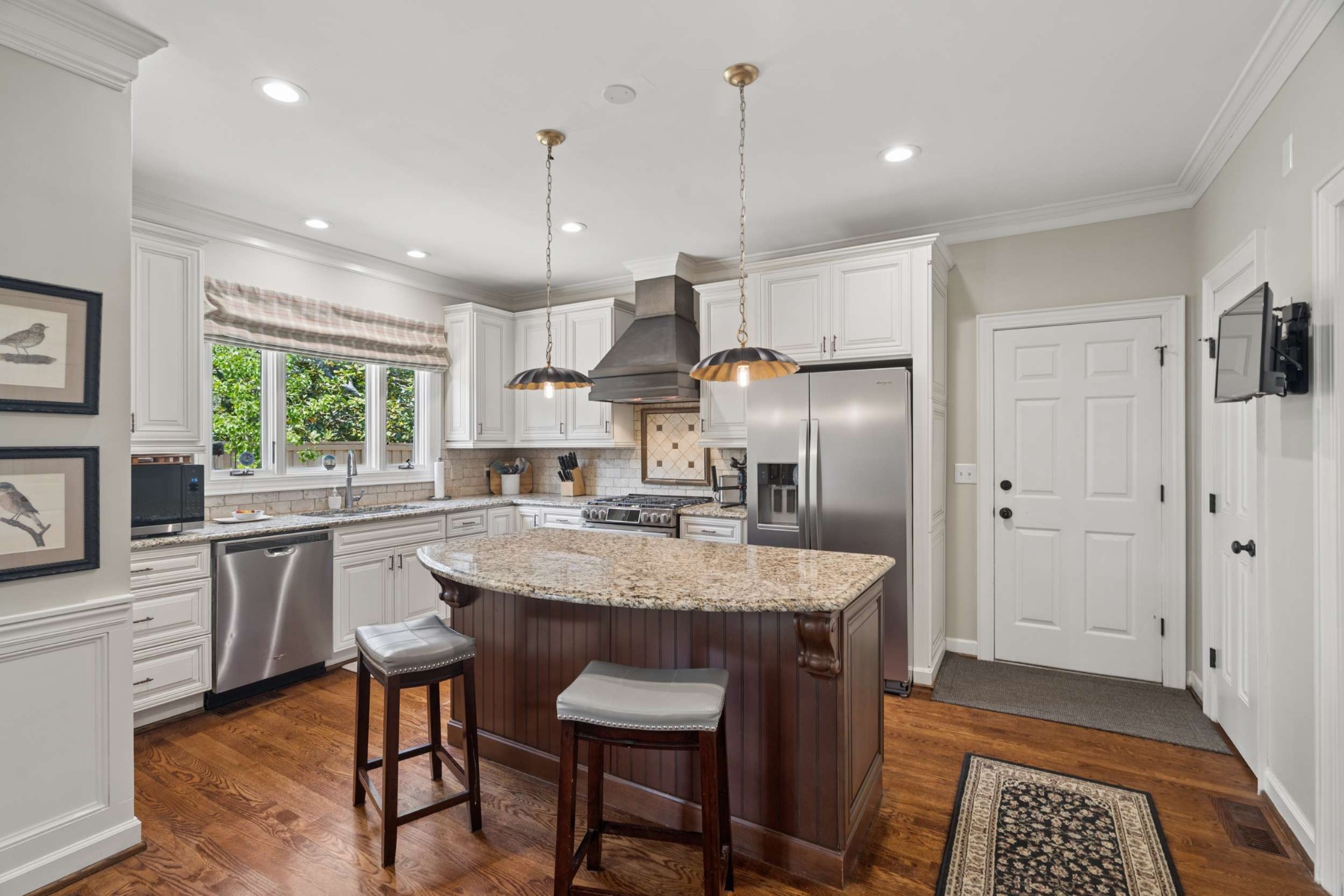 2723 Abbott Martin Road Nashville, TN 37215 - Photo 19 of 45 a kitchen with stainless steel appliances granite countertop a sink a stove a refrigerator cabinets and chairs