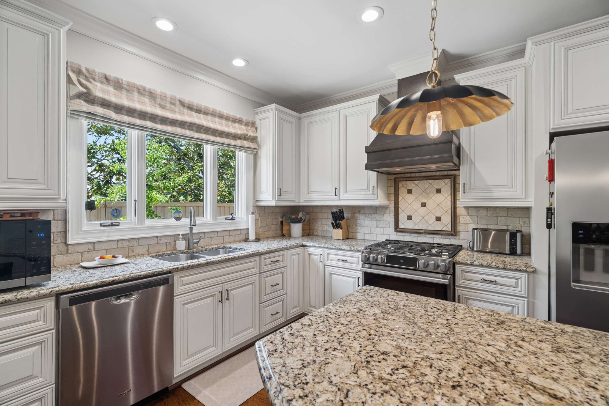2723 Abbott Martin Road Nashville, TN 37215 - Photo 20 of 45 a kitchen with stainless steel appliances granite countertop a stove a sink dishwasher and cabinets with wooden floor