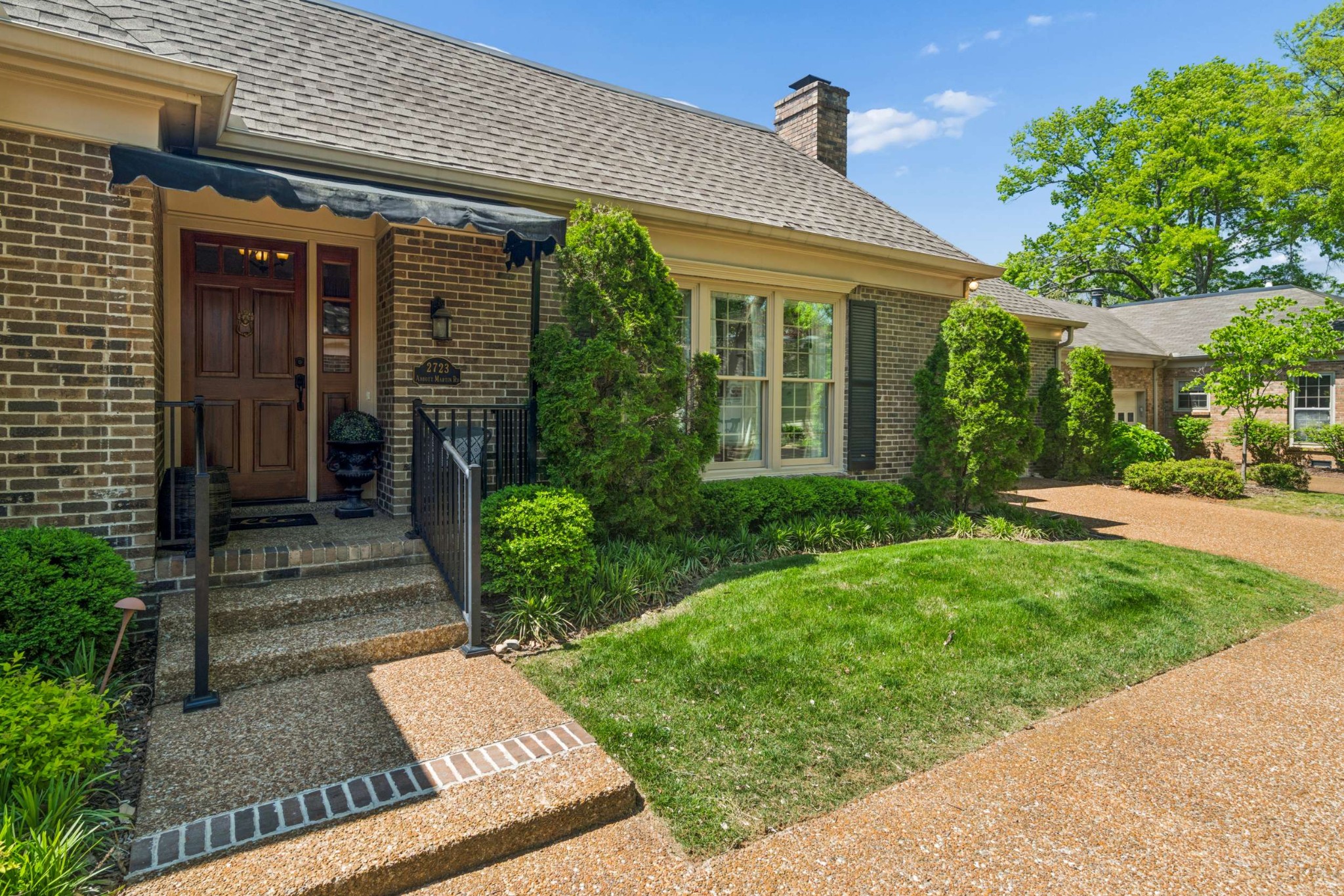 2723 Abbott Martin Road Nashville, TN 37215 - Photo 2 of 45 a front view of a house with garden